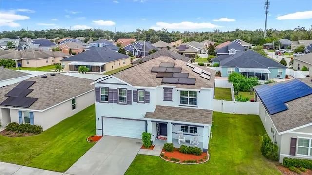 a dining room with furniture and a potted plant