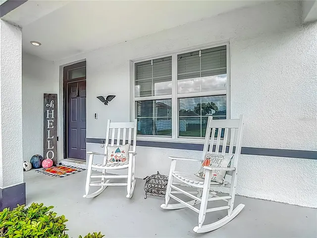 a bedroom with furniture and a wooden floor