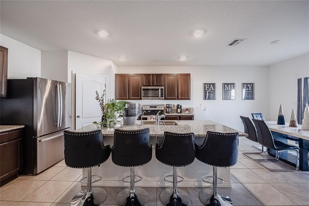 3883 Resting Robin Avenue Bartow, FL 33830 - Photo 16 of 44 a kitchen with a dining table and chairs