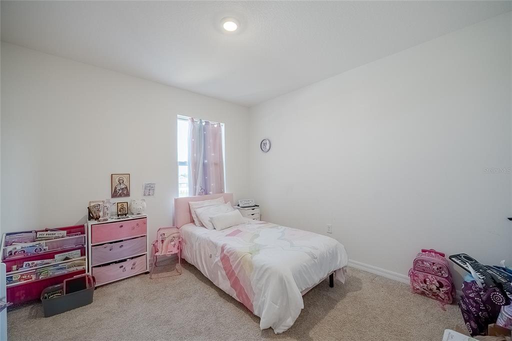 3883 Resting Robin Avenue Bartow, FL 33830 - Photo 24 of 44 a bedroom with a bed and a dresser