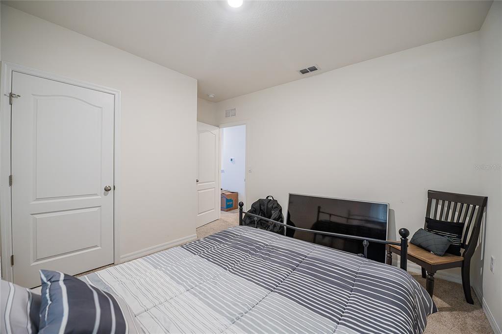 3883 Resting Robin Avenue Bartow, FL 33830 - Photo 30 of 44 a bedroom with a bed and chair