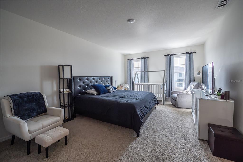 3883 Resting Robin Avenue Bartow, FL 33830 - Photo 35 of 44 a spacious bedroom with a bed a couch and a couch