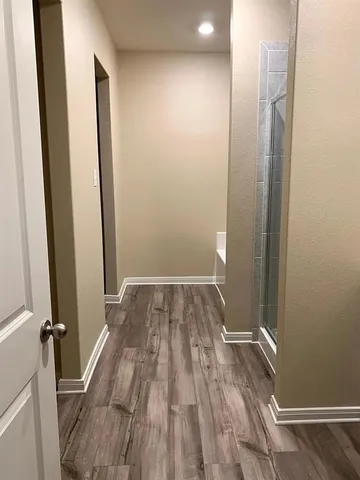 a view of a room with wooden floor and a staircase