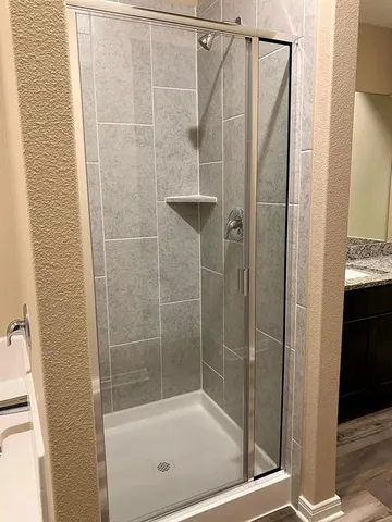 a bathroom with a shower and a sink
