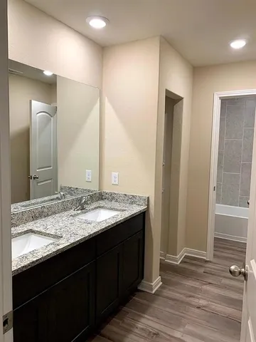 a bathroom with a granite countertop sink and a mirror