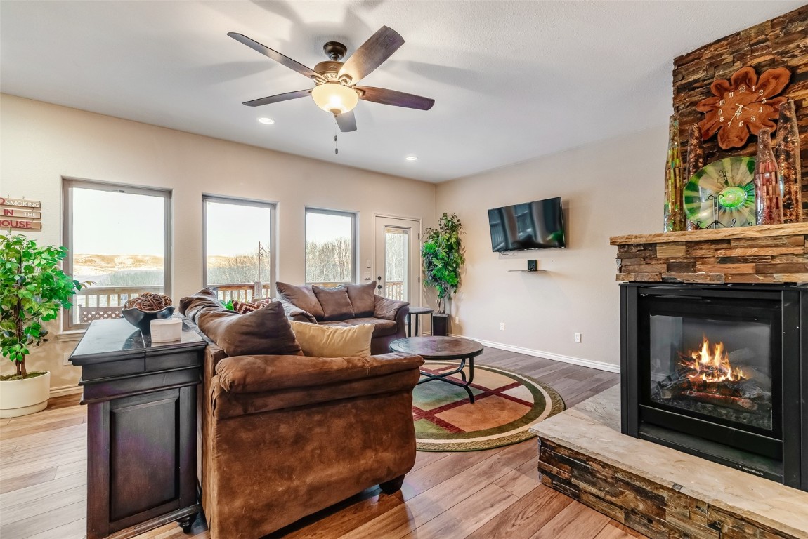 53 Anhinga Road Como, CO 80432 - Photo 11 of 45 a living room with furniture a fireplace and a flat screen tv