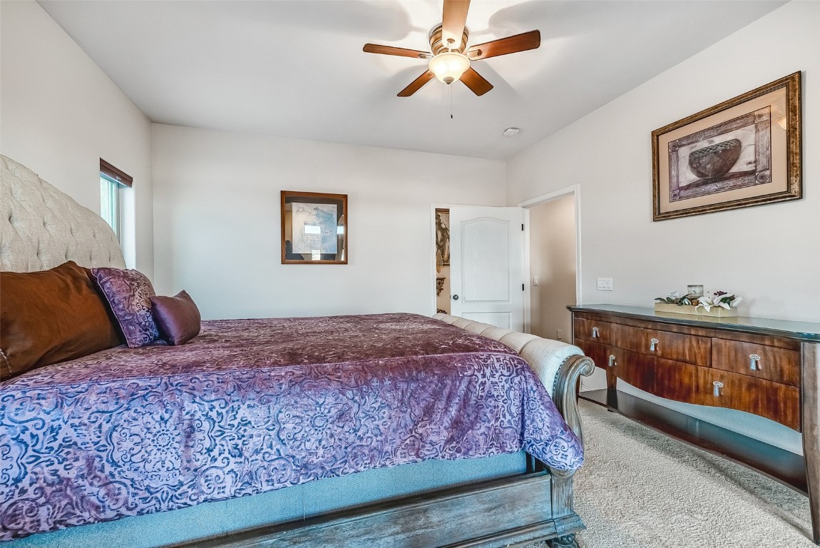 53 Anhinga Road Como, CO 80432 - Photo 16 of 45 a bedroom with a large bed and a chandelier