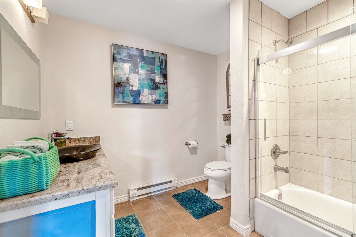 53 Anhinga Road Como, CO 80432 - Photo 31 of 45 a bathroom with a granite countertop sink a toilet a mirror and shower