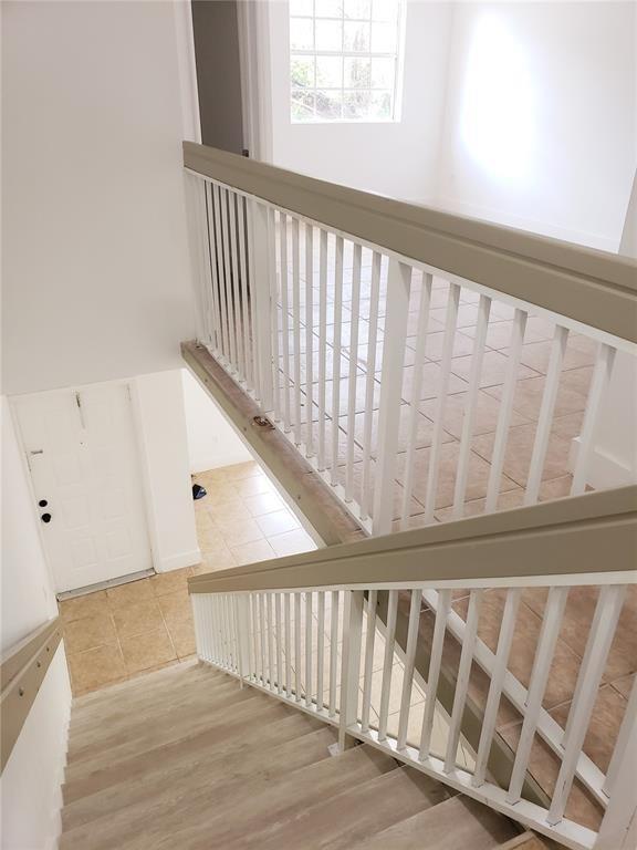 18338 Northwest 68th Avenue, Unit B Hialeah, FL 33015 - Photo 11 of 21 a view of a hallway with wooden floor and stairs