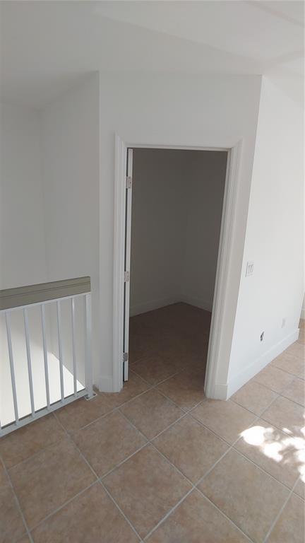 18338 Northwest 68th Avenue, Unit B Hialeah, FL 33015 - Photo 13 of 21 a view of an empty room with a window
