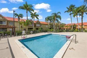 18338 Northwest 68th Avenue, Unit B Hialeah, FL 33015 - Photo 17 of 21 a view of swimming pool with a table and chairs