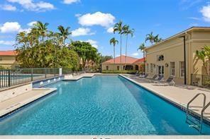 18338 Northwest 68th Avenue, Unit B Hialeah, FL 33015 - Photo 18 of 21 a view of a swimming pool with a patio