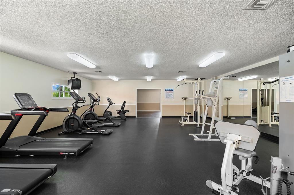 18338 Northwest 68th Avenue, Unit B Hialeah, FL 33015 - Photo 20 of 21 a view of a room with gym equipment