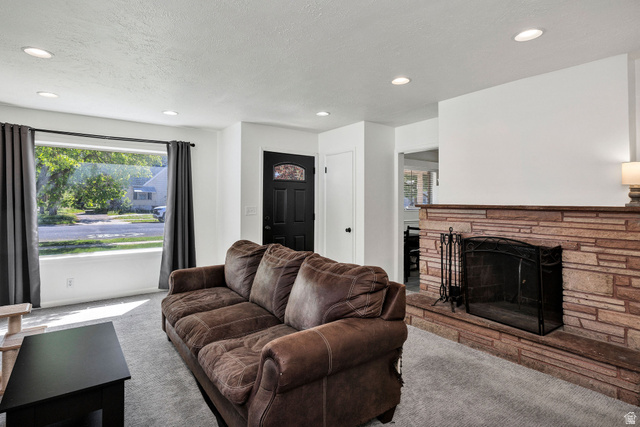 667 North 100 East Logan, UT 84321 - Photo 14 of 41 Carpeted living room with a fireplace, recessed lighting,