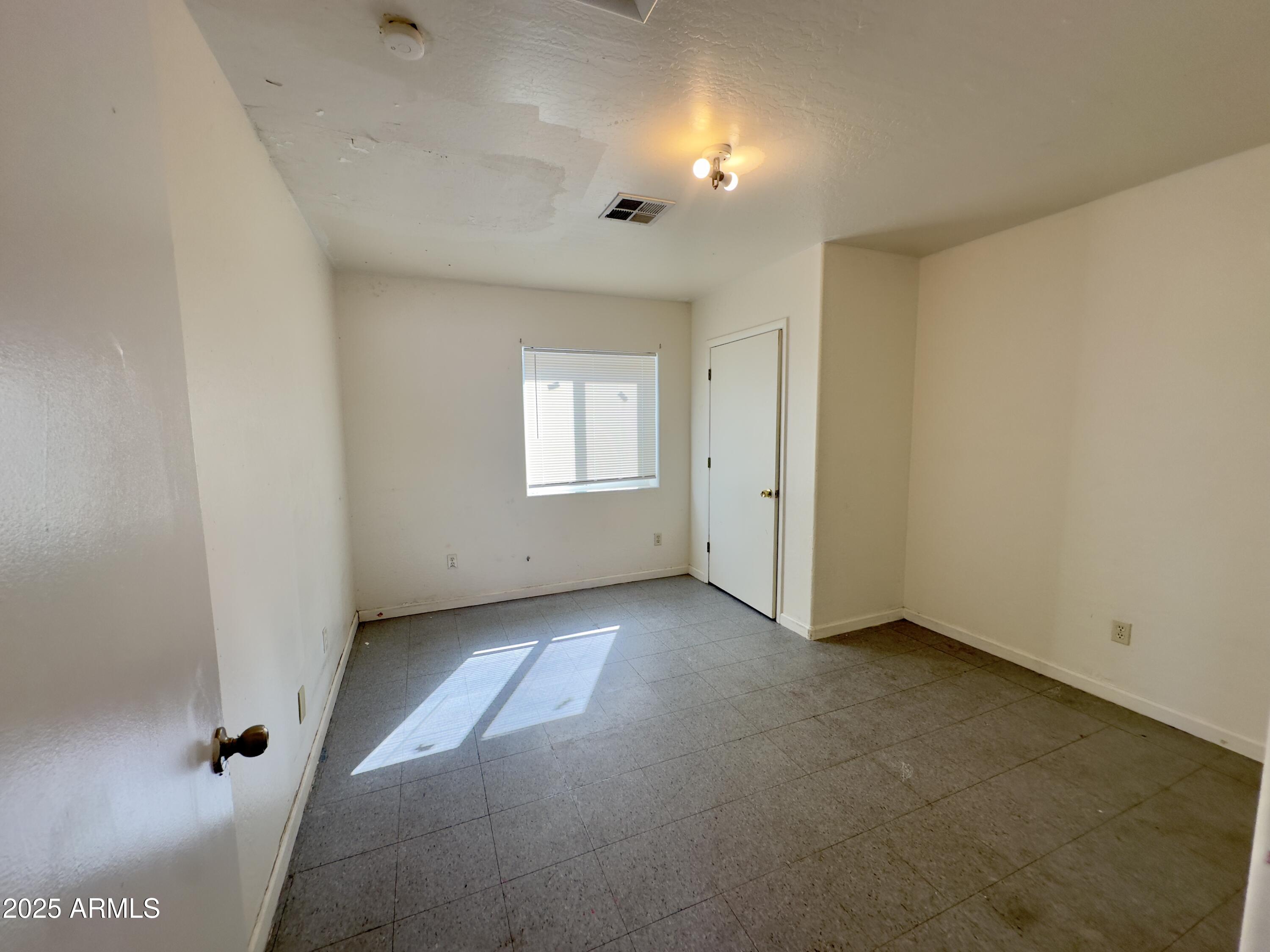 1228 East Apache Street, Unit 2 Phoenix, AZ 85034 - Photo 12 of 15 an empty room with windows