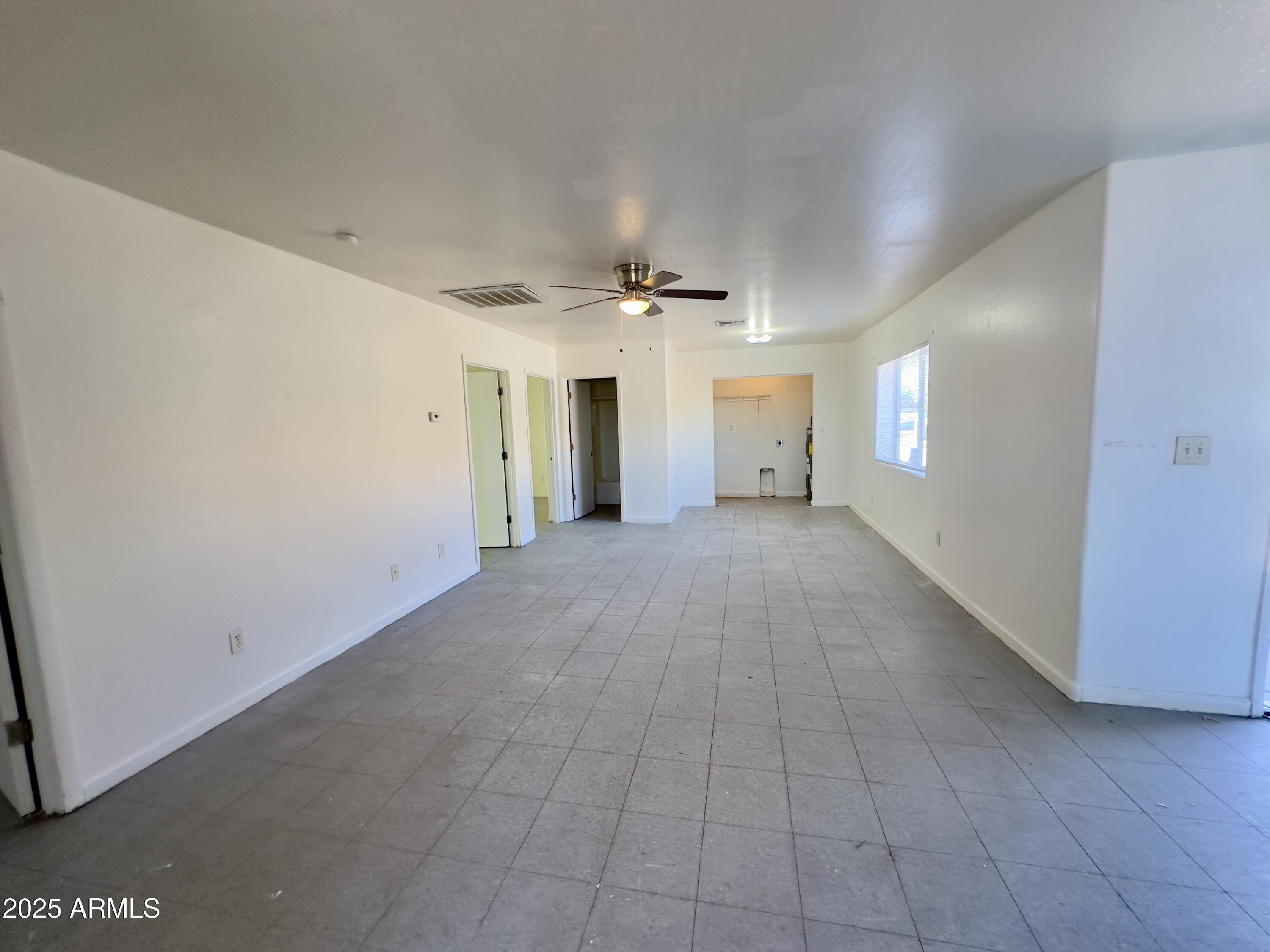 1228 East Apache Street, Unit 2 Phoenix, AZ 85034 - Photo 2 of 15 a view of a livingroom with a ceiling fan and window