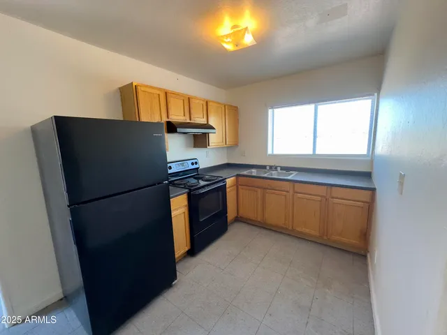 a kitchen with a refrigerator sink and window