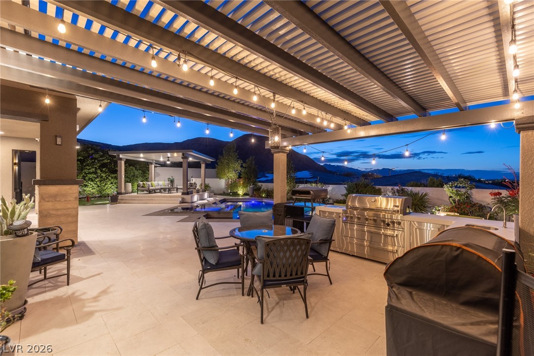10118 Copper Edge Road Las Vegas, NV 89148 - Photo 34 of 48 An entertainer's dream, this expansive patio offers an outdoor kitchen, shimmering pool, and stunning mountain views.