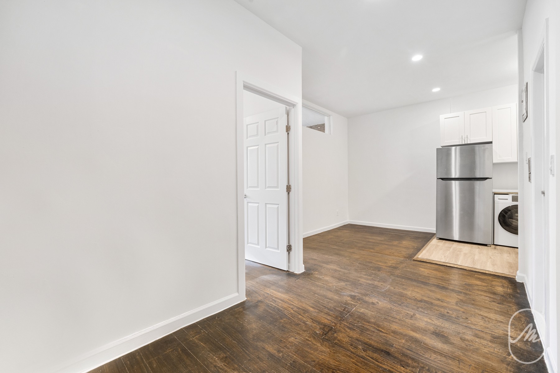 a view of a kitchen with a sink and a refrigerator
