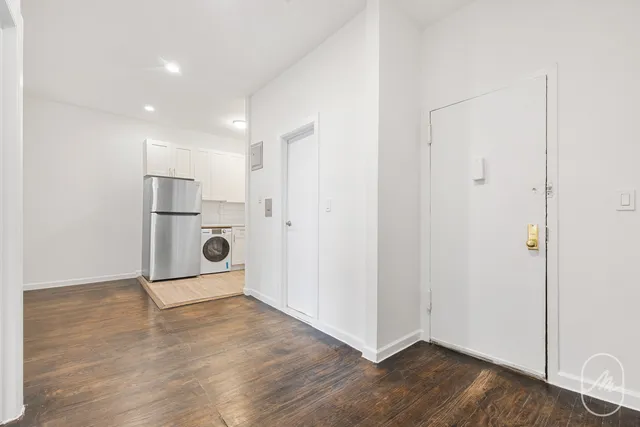 a view of a kitchen with a sink and a refrigerator
