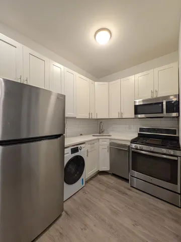 a view of a kitchen with a refrigerator a stove top oven a refrigerator and a dishwasher