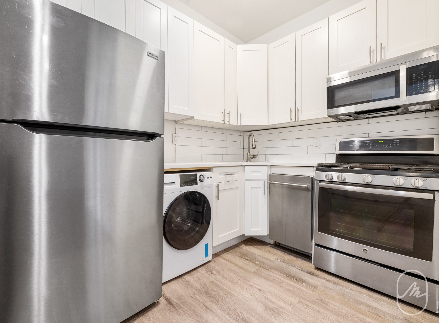 309 West 29th Street, Unit 2R Manhattan, NY 10001 - Photo 5 of 11 a kitchen with a stove and a microwave