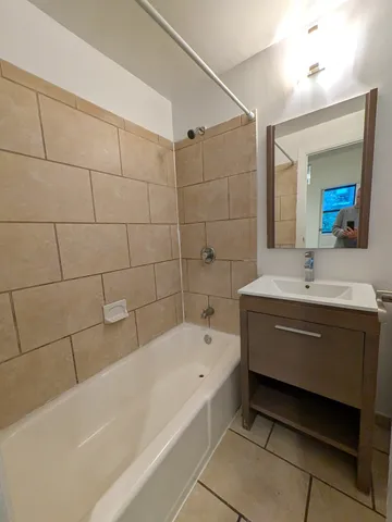 a kitchen with a refrigerator sink stove and cabinets