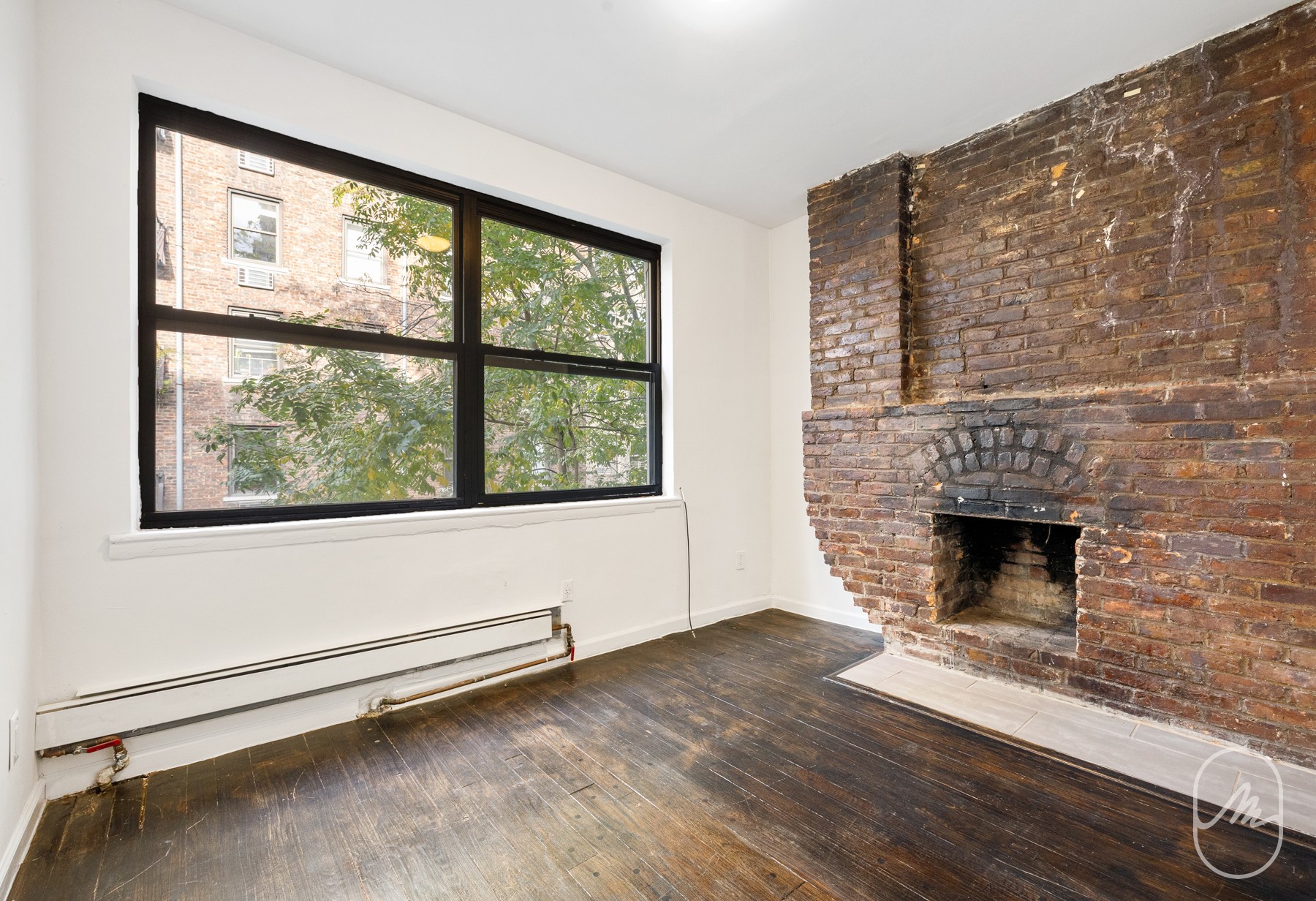 309 West 29th Street, Unit 2R Manhattan, NY 10001 - Photo 6 of 11 a living room with a fireplace and a floor to ceiling window