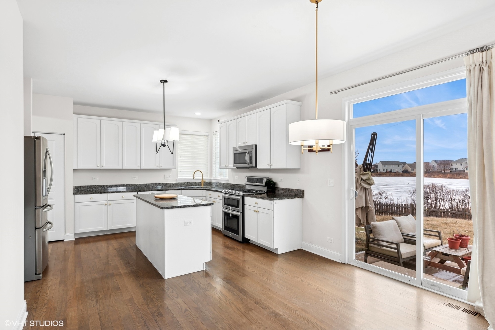 361 Minuet Circle Volo, IL 60073 - Photo 6 of 19 a kitchen with stainless steel appliances and white cabinets
