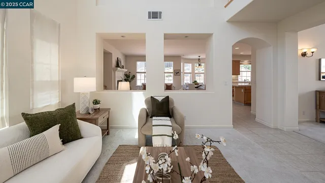 a living room with furniture and a chandelier