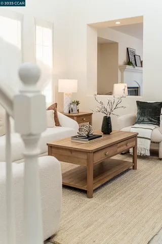a living room with furniture a flat screen tv and a window
