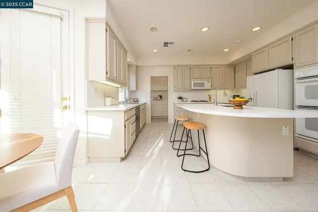 a kitchen with refrigerator and cabinets