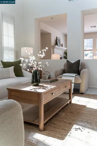 a living room with furniture and a mirror