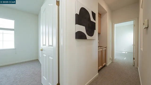 a bedroom with a bed couch and a large window