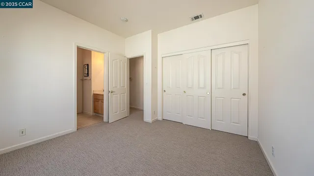 a view of a bedroom with furniture and a window
