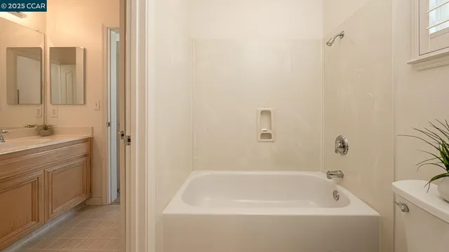 a bathroom with a double vanity sink a mirror and a shower