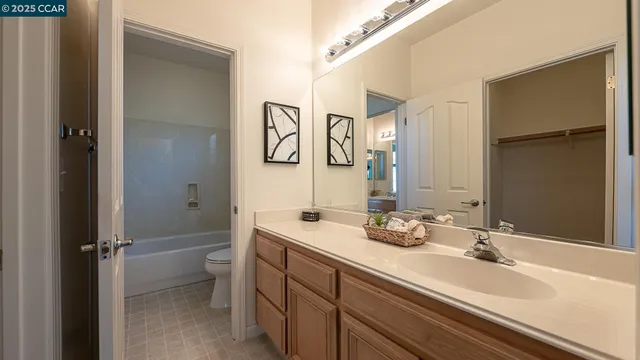 a bathroom with a tub sink and mirror