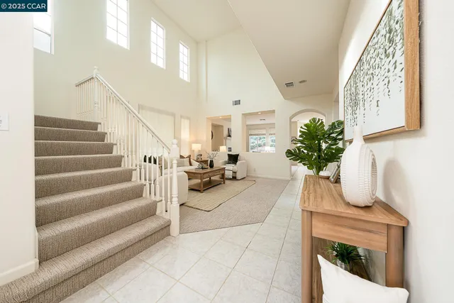 a living room with furniture and a lamp