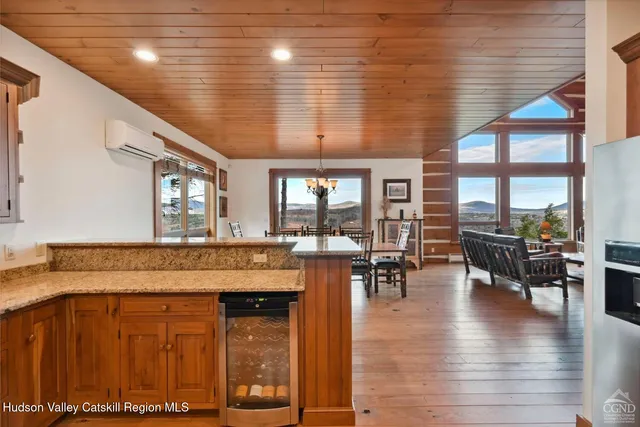a dining room with furniture water view and large windows