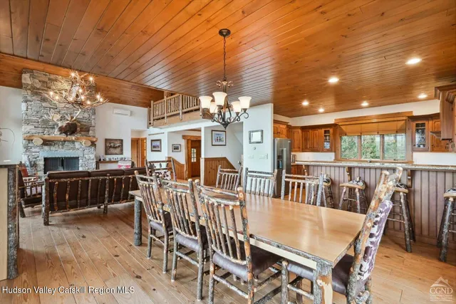 a dining room with furniture window and wooden floor