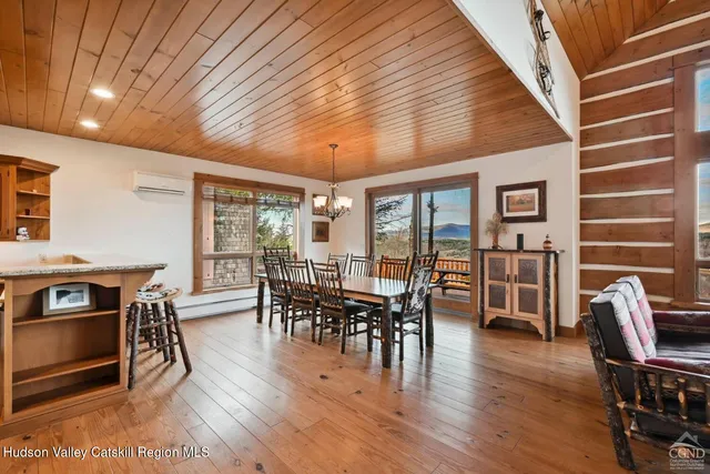 a bathroom with a granite countertop sink a large mirror and a bathtub