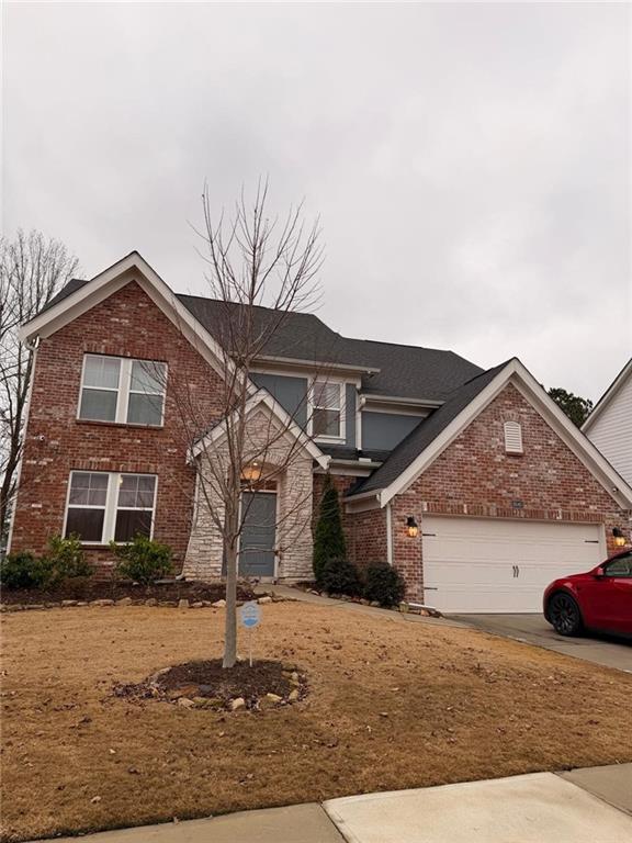 a front view of a house with a yard