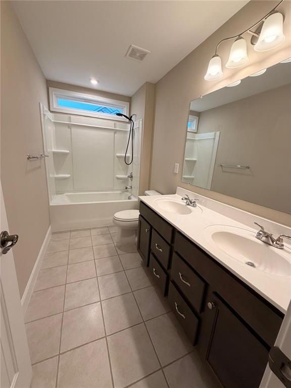 8040 Scenic Ridge Way Ball Ground, GA 30107 - Photo 14 of 35 a bathroom with a sink a toilet a mirror and bathtub