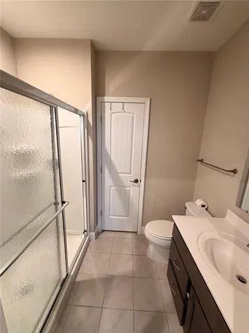 a bathroom with a granite countertop sink toilet and mirror