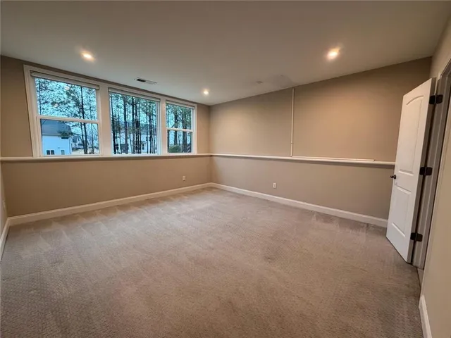 an empty room with a empty space and windows