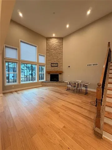 a view of a livingroom with wooden floor and stairs