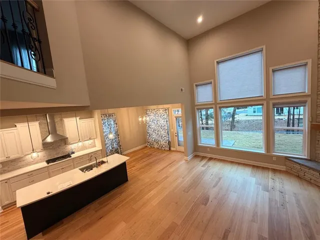 a view of workspace with furniture and large windows