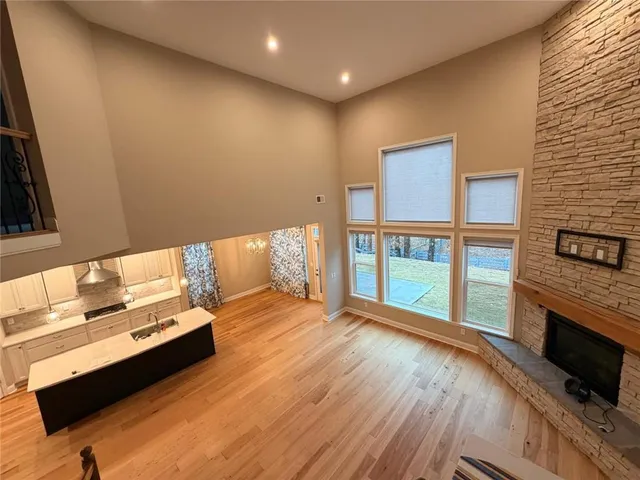 a spacious bedroom with a bed and a tv