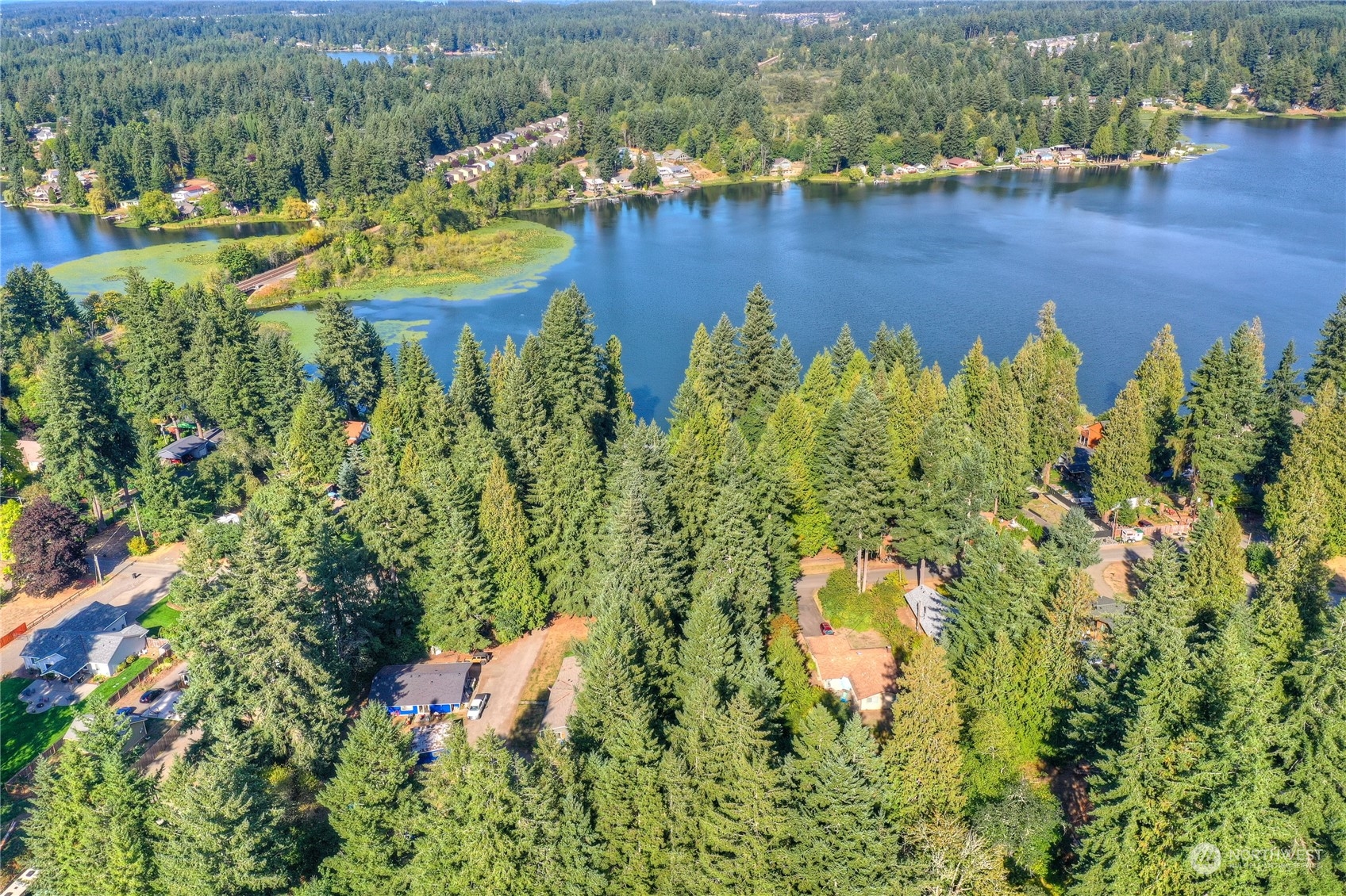7349 Fair Oaks Road Southeast Olympia, WA 98513 - Photo 1 of 6 an aerial view of residential houses with outdoor space and lake view