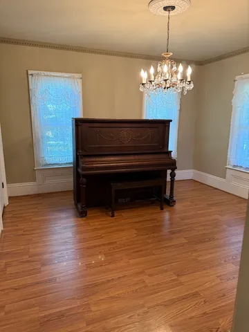 a view of dining room with furniture and wooden floor